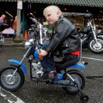 Five-year-old Camden Belvins-Mohr revs up his training wheel equipped motorcycle as he cruises down First Street during the Sky Valley Antique & Classic Motorcyle Show Sunday afternoon in Snohomish. 